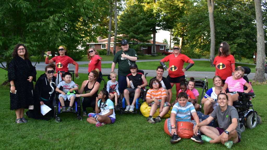 Discovery Camp - Councilors wearing incredibles shirts pose with campers