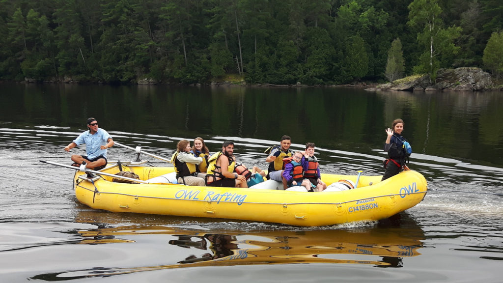 Sports Camp - A group of campers in a large white water raft