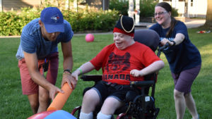 GEAR-UP - councilors assist a camper on the field